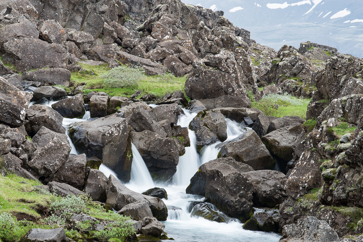 Volcanic rocks and a rushing stream in Þingvellir National Park